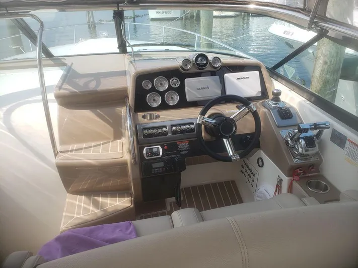  Yacht Photos Pics 2014 Formula 350 Sun Sport boat cockpit with steering wheel and control panel.