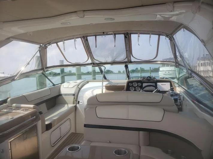  Yacht Photos Pics 2014 Formula 350 Sun Sport boat interior with beige seating and dashboard controls.