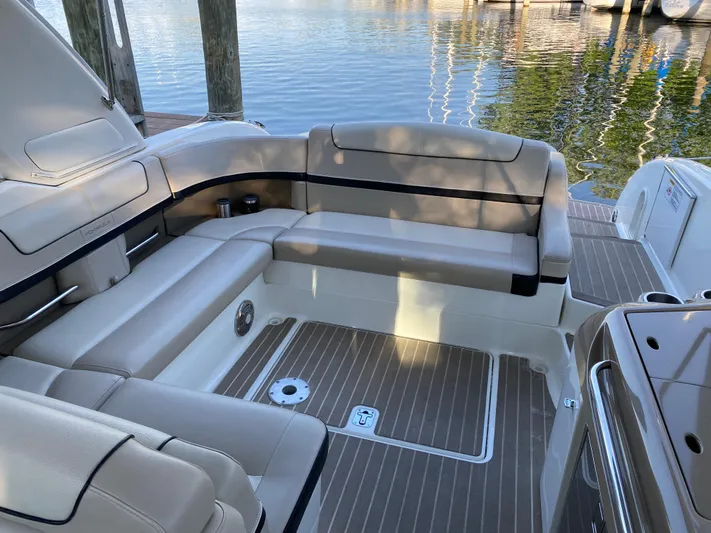  Yacht Photos Pics 2014 Formula 350 Sun Sport boat interior with beige seating and wood accents by the water.
