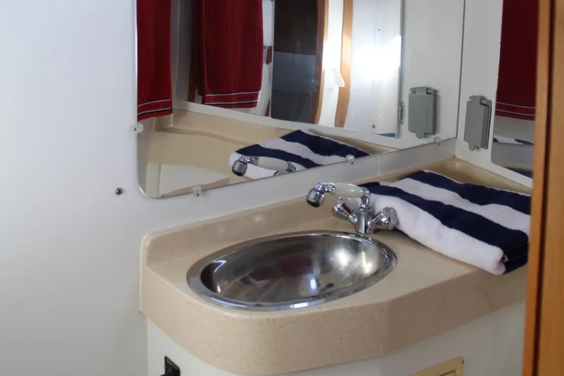 Cuckoo's Nest II Yacht Photos Pics Bathroom sink area in a 2002 Catalina MkII yacht with mirror and towel.
