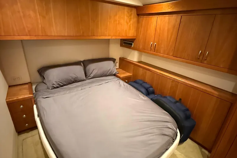 Yacht Photos Pics Luxurious 2013 Hatteras GT54 yacht bedroom with wooden cabinetry and cozy bedding.