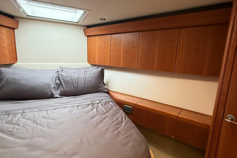  Yacht Photos Pics Luxurious cabin interior of 2013 Hatteras GT54 yacht with wood paneling and skylight.