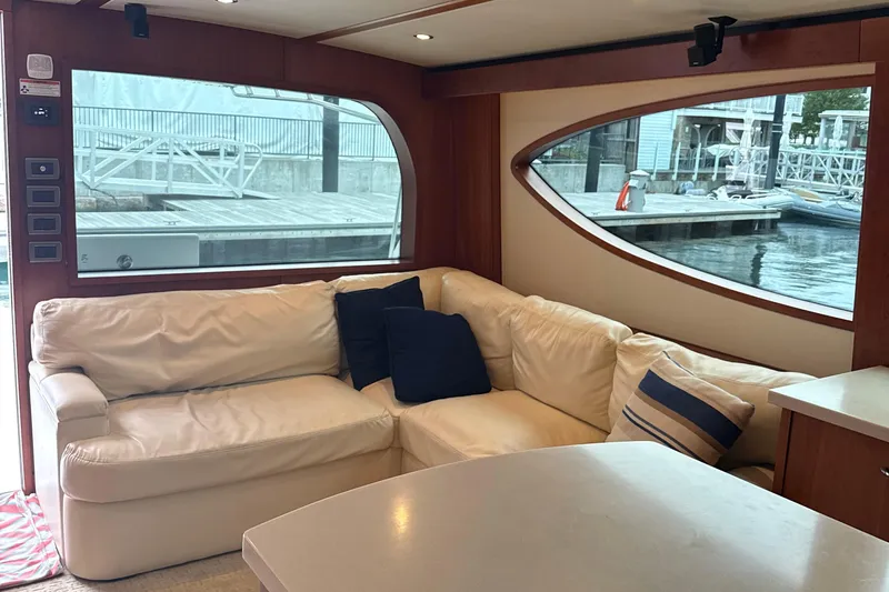  Yacht Photos Pics Luxurious interior of 2013 Hatteras GT54 yacht with white leather seating and marina view.