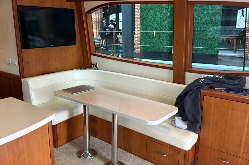  Yacht Photos Pics Interior of 2013 Hatteras GT54 yacht with white seating and table.