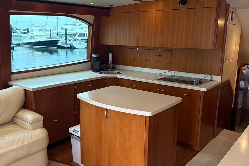  Yacht Photos Pics Luxurious 2013 Hatteras GT54 yacht interior with modern kitchen and marina view.
