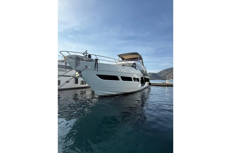  Yacht Photos Pics Luxury 2020 Princess Y78 yacht docked on serene water under clear sky.