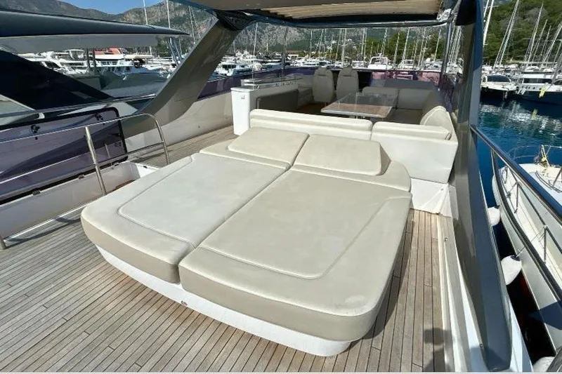  Yacht Photos Pics Luxurious 2020 Princess Y78 yacht deck with sun loungers and seating area in marina.