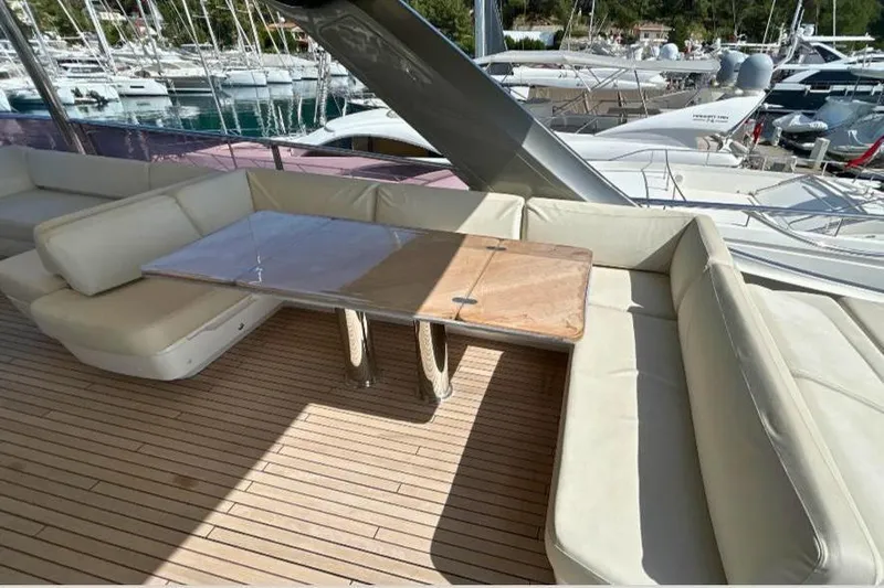  Yacht Photos Pics Luxury seating area on 2020 Princess Y78 yacht with wooden deck and table.