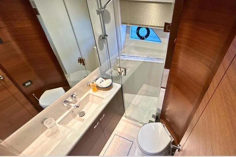  Yacht Photos Pics Luxurious bathroom in 2020 Princess Y78 yacht with modern fixtures and wooden accents.