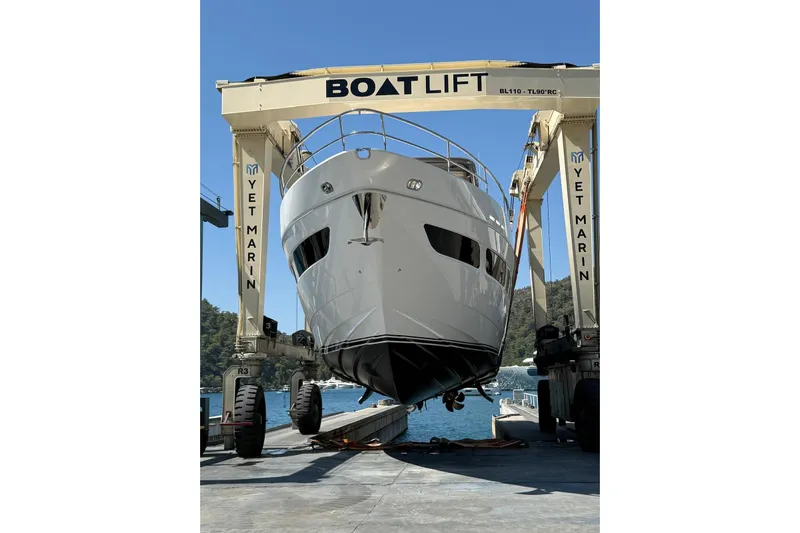  Yacht Photos Pics 2020 Princess Y78 yacht on boat lift at marina, clear sky background.
