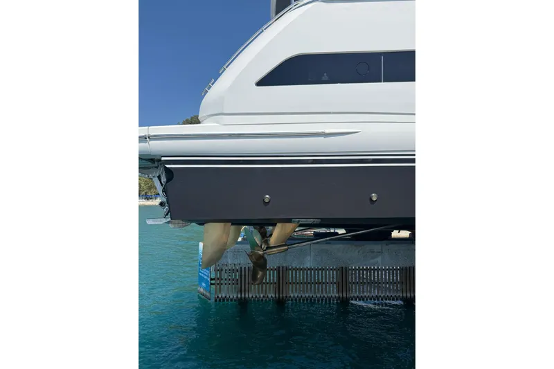  Yacht Photos Pics 2020 Princess Y78 yacht side view with propeller, docked in clear blue water.