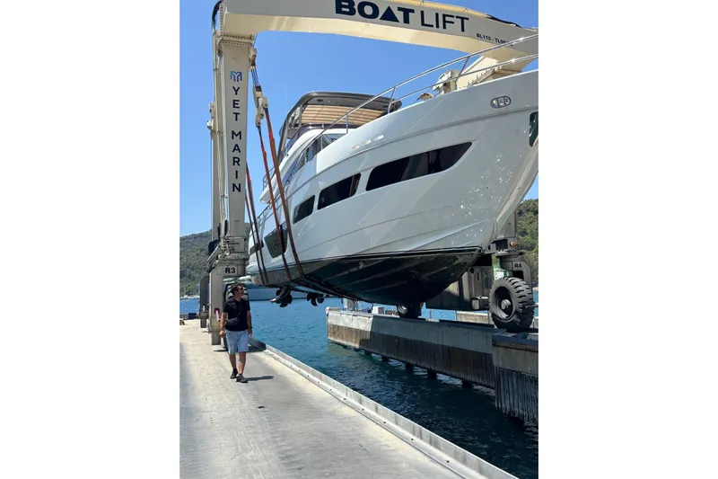  Yacht Photos Pics 2020 Princess Y78 yacht lifted by crane at marina dockside.