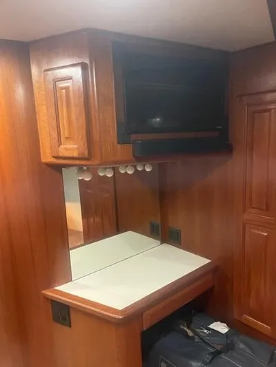Dry-hydro Yacht Photos Pics 1990 Viking Convertible interior with wooden cabinetry, mirror, and TV.