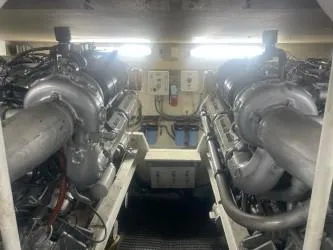 Dry-hydro Yacht Photos Pics Engine room of a 1990 Viking Convertible boat, featuring dual engines and control panels.