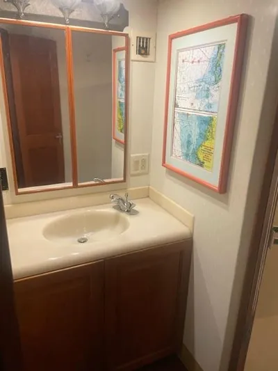Dry-hydro Yacht Photos Pics Bathroom vanity with mirror and framed map, inside a 1990 Viking Convertible.