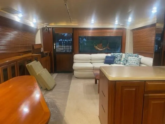 Dry-hydro Yacht Photos Pics Luxurious interior of a 1990 Viking Convertible yacht with plush seating and wooden accents.