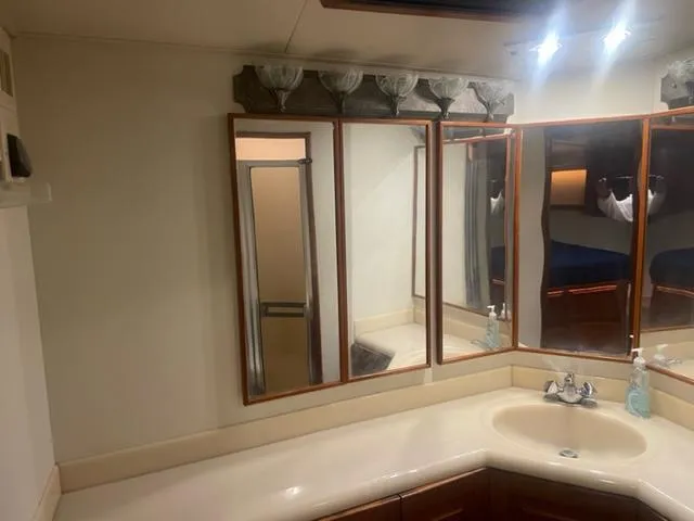 Dry-hydro Yacht Photos Pics Bathroom vanity with mirrors and sink in a 1990 Viking Convertible boat.