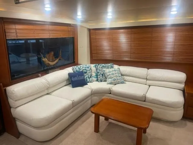Dry-hydro Yacht Photos Pics Luxurious interior of a 1990 Viking Convertible yacht with white leather seating and wooden blinds.