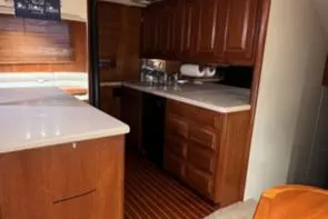 Dry-hydro Yacht Photos Pics 1990 Viking Convertible yacht interior with wooden cabinetry and countertops.