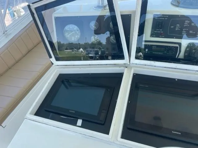 Dry-hydro Yacht Photos Pics 1990 Viking Convertible boat dashboard with navigation screens and gauges.