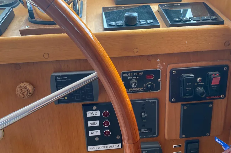 Lord Stanley Yacht Photos Pics 1988 Lyman-Morse Jarvis Newman Cruiser helm with controls and wooden steering wheel.