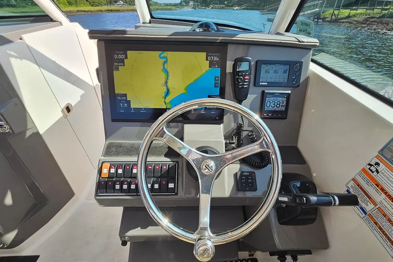  Yacht Photos Pics 2018 Pursuit DC 295 Dual Console boat dashboard with navigation and control systems.