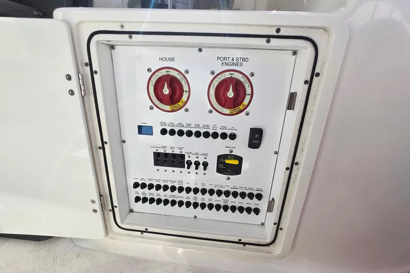  Yacht Photos Pics Control panel of a 2018 Pursuit DC 295 Dual Console boat, featuring switches and dials.