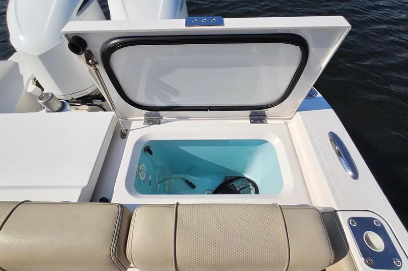  Yacht Photos Pics 2018 Pursuit DC 295 Dual Console boat with open storage compartment.