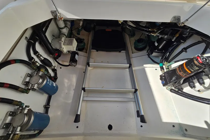  Yacht Photos Pics 2018 Pursuit DC 295 Dual Console engine compartment with ladder and mechanical components.