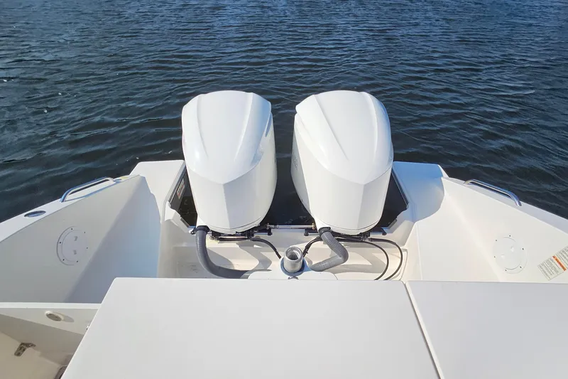  Yacht Photos Pics 2018 Pursuit DC 295 Dual Console boat with twin outboard engines on water.