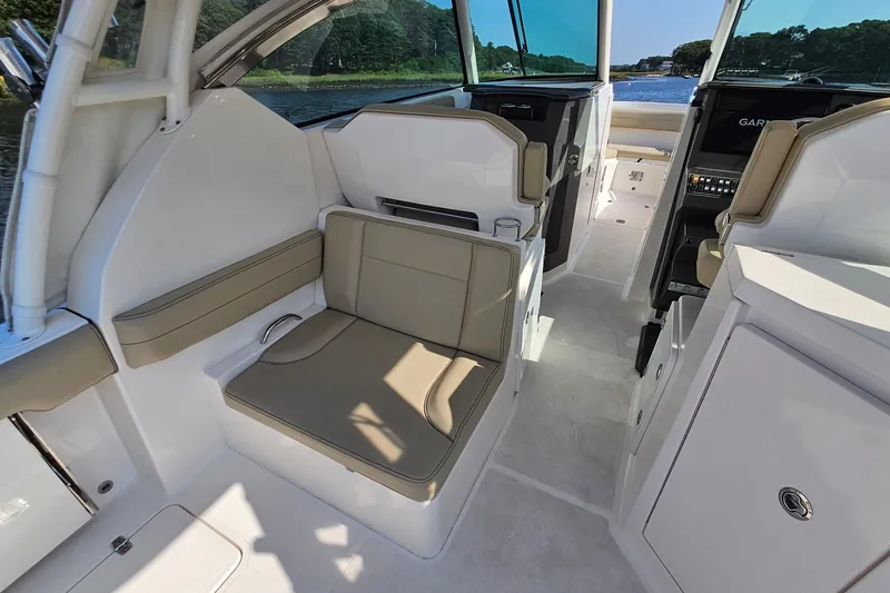  Yacht Photos Pics 2018 Pursuit DC 295 Dual Console interior with beige seating and modern dashboard.