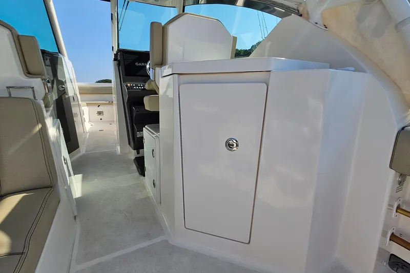  Yacht Photos Pics 2018 Pursuit DC 295 Dual Console interior with seating and storage compartments.