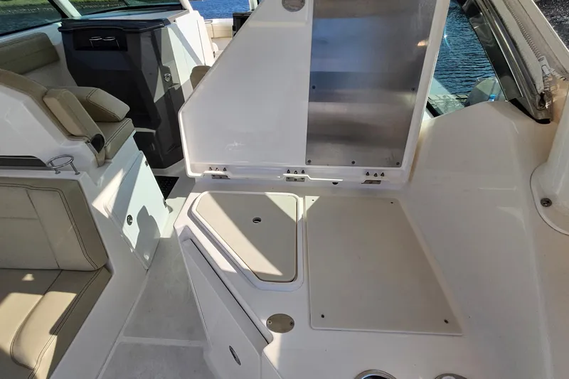  Yacht Photos Pics 2018 Pursuit DC 295 Dual Console interior with seating and storage compartments.