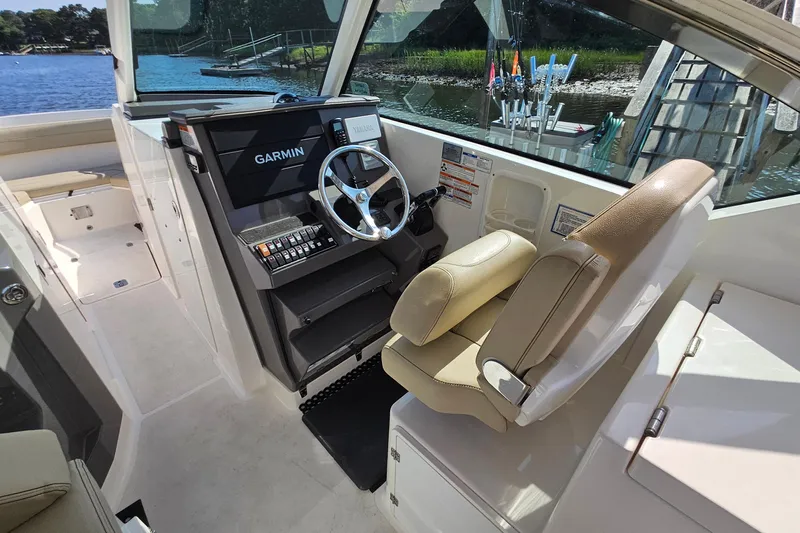  Yacht Photos Pics 2018 Pursuit DC 295 Dual Console boat interior with Garmin navigation system and comfortable seating.