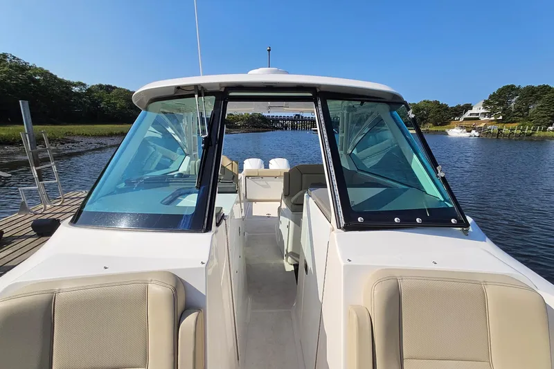  Yacht Photos Pics 2018 Pursuit DC 295 Dual Console boat docked on a sunny day.