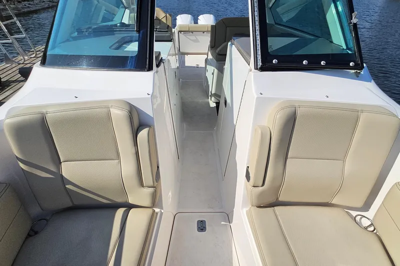  Yacht Photos Pics 2018 Pursuit DC 295 Dual Console boat interior with beige seating and windshield.