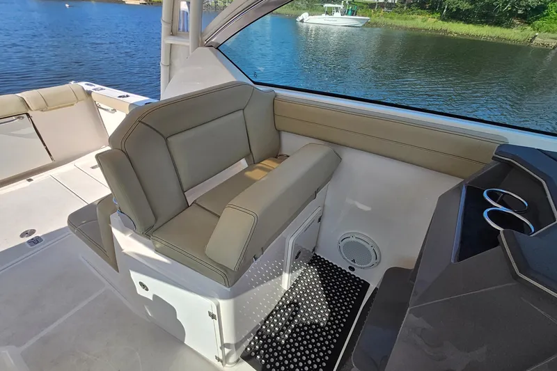  Yacht Photos Pics 2018 Pursuit DC 295 Dual Console boat interior with seating and water view.