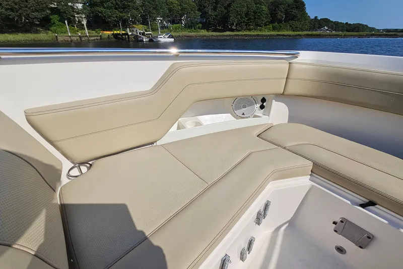  Yacht Photos Pics 2018 Pursuit DC 295 Dual Console boat interior with beige seating and speaker.