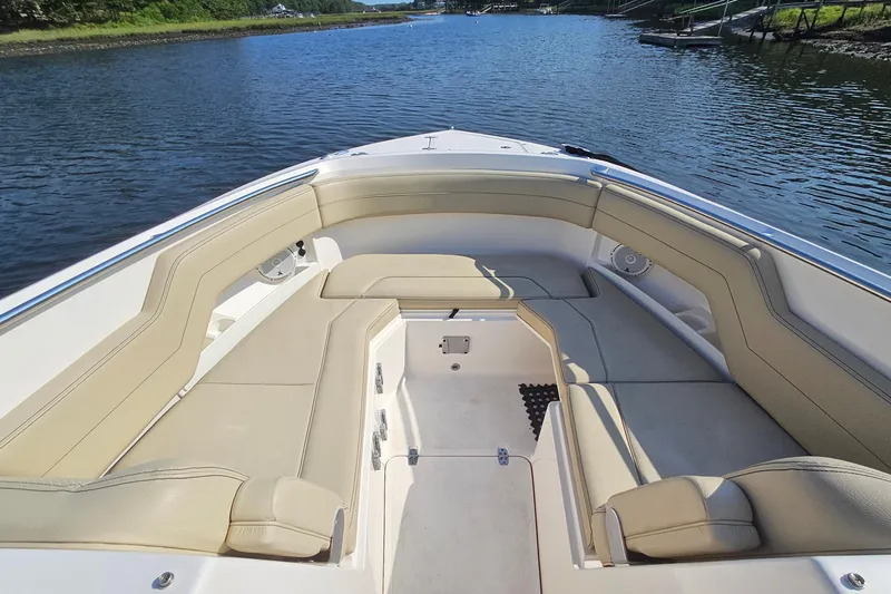  Yacht Photos Pics 2018 Pursuit DC 295 Dual Console boat interior with beige seating on calm water.