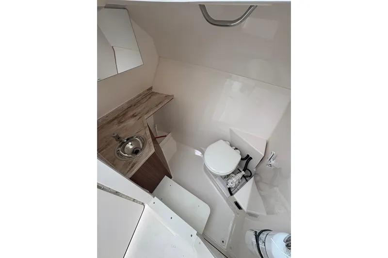  Yacht Photos Pics 2018 Pursuit DC 295 Dual Console boat interior with sink and toilet.