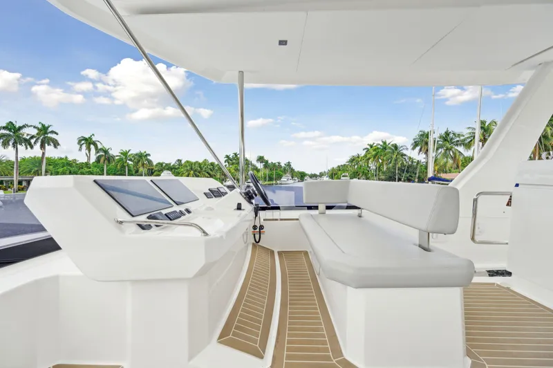 Euphoria Yacht Photos Pics 2024 Leopard 53 Powercat helm with modern controls and seating, surrounded by tropical scenery.