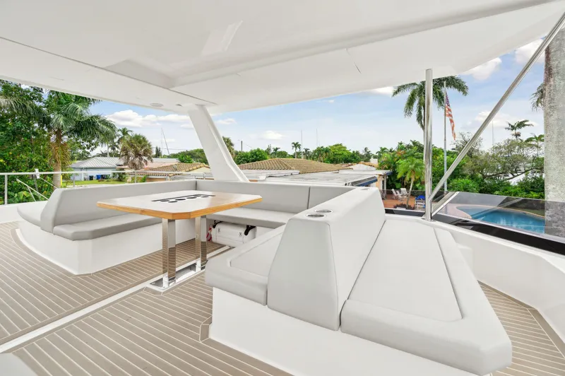 Euphoria Yacht Photos Pics Luxurious 2024 Leopard 53 Powercat yacht with spacious outdoor seating and table.