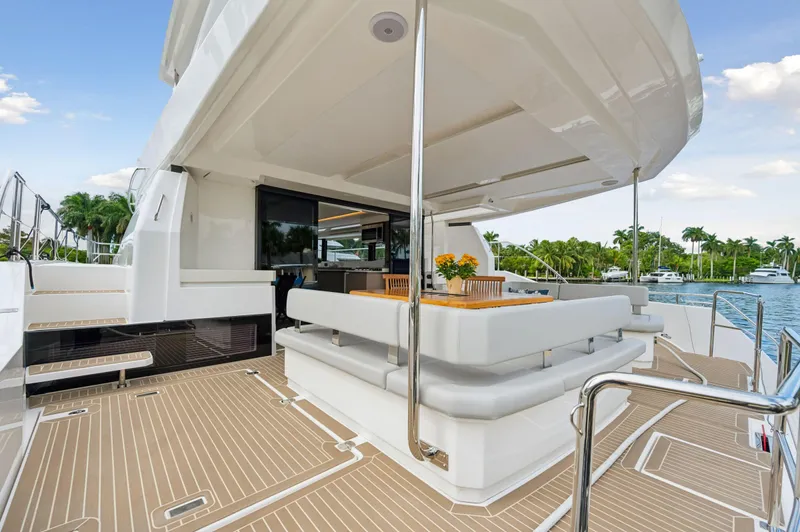 Euphoria Yacht Photos Pics 2024 Leopard 53 Powercat yacht with elegant outdoor seating and scenic marina view.