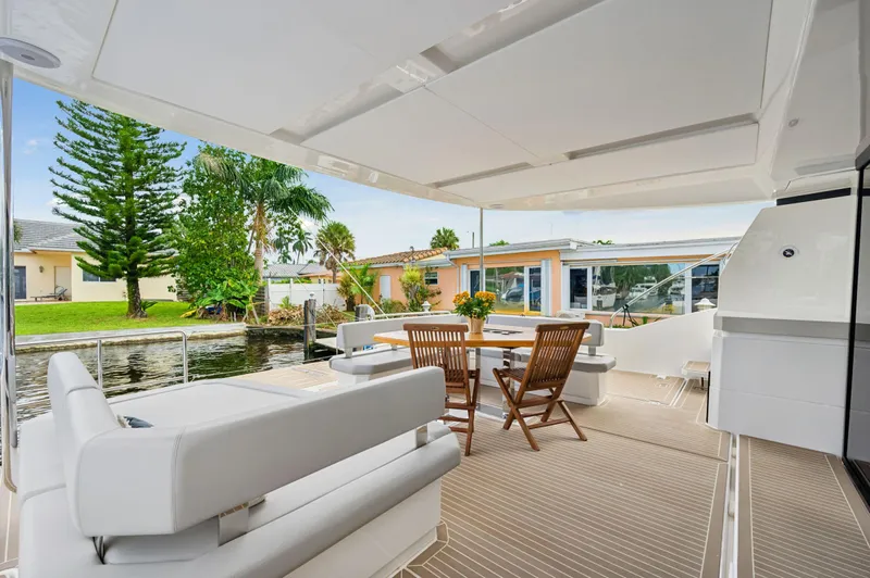 Euphoria Yacht Photos Pics 2024 Leopard 53 Powercat yacht deck with seating and dining area.