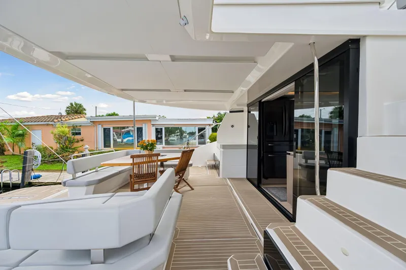 Euphoria Yacht Photos Pics 2024 Leopard 53 Powercat yacht deck with modern seating and dining area.