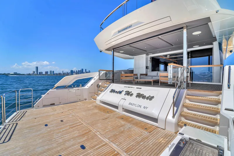 Worth The Wait Yacht Photos Pics 2024 Sunseeker Ocean 182 yacht with spacious deck and city skyline view.
