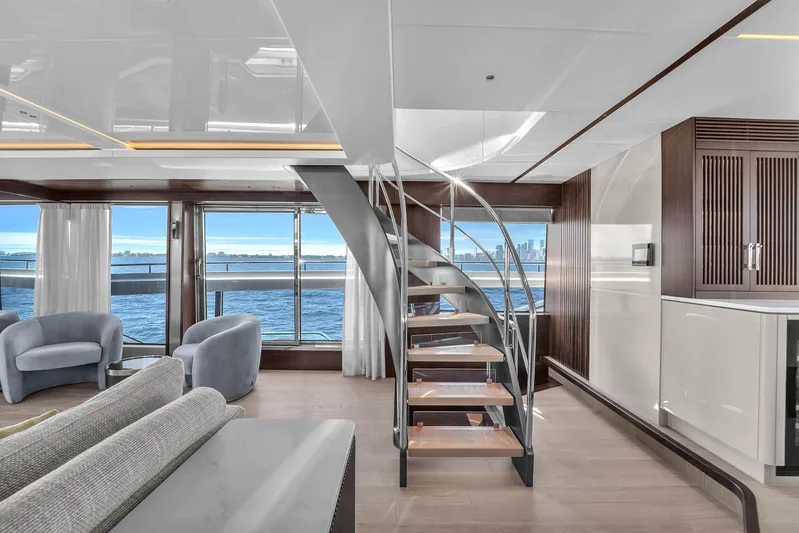 Worth The Wait Yacht Photos Pics Luxurious interior of 2024 Sunseeker Ocean 182 yacht with modern staircase and ocean view.