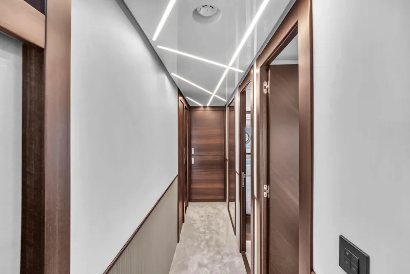 Worth The Wait Yacht Photos Pics Luxurious hallway interior of 2024 Sunseeker Ocean 182 yacht with modern lighting.