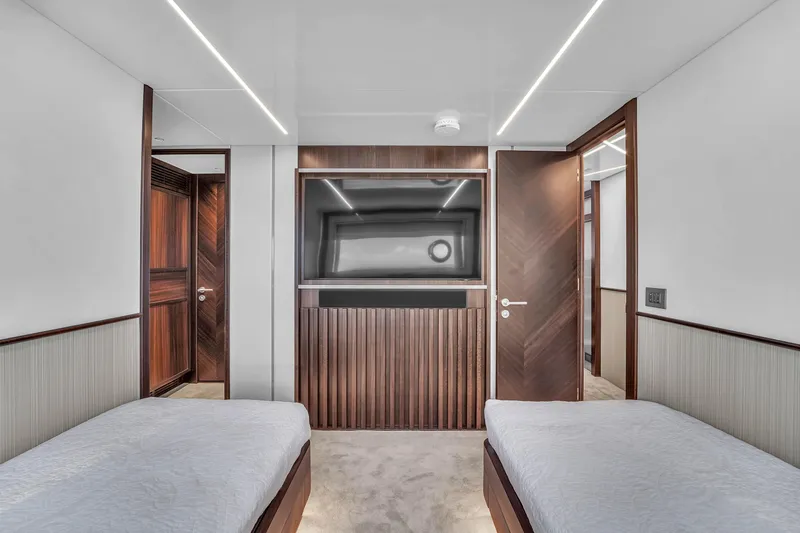 Worth The Wait Yacht Photos Pics Luxurious interior of 2024 Sunseeker Ocean 182 yacht with twin beds and modern design.