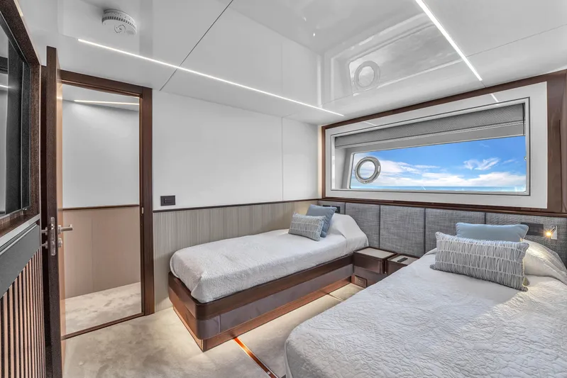 Worth The Wait Yacht Photos Pics Luxurious cabin interior of 2024 Sunseeker Ocean 182 yacht with twin beds and ocean view.